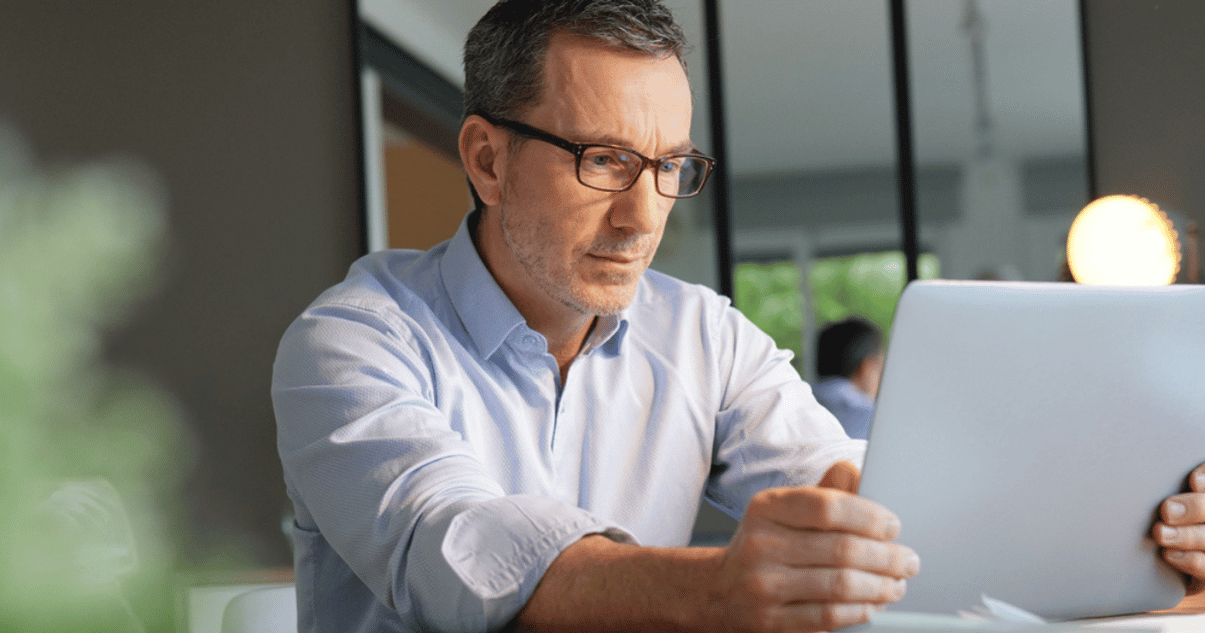 Man working on his laptop checking the security of his billing platform