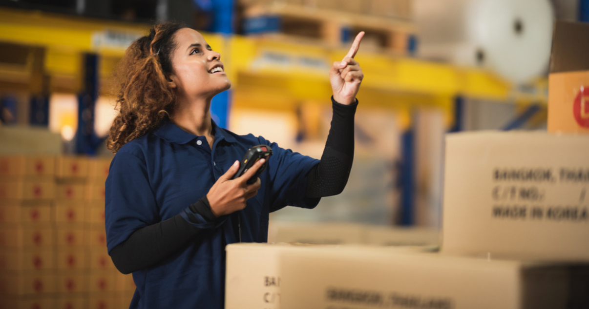 Woman working at a warehouse full of boxes from ecommerce purchases